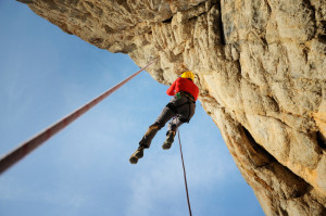 Rescuer climbs on rock